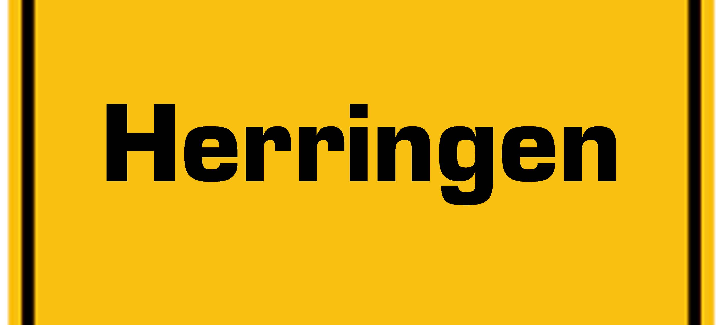 Ortseingangsschild gelb mit schwarzer Aufschrift Herringen